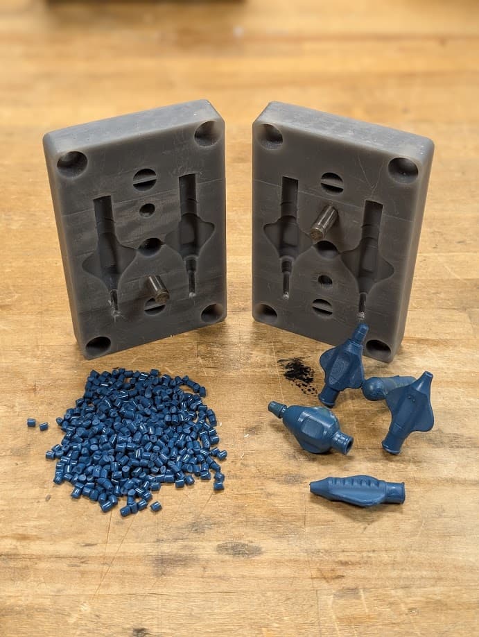 3D printed injection mold tool with pellet resin and injection molded parts.